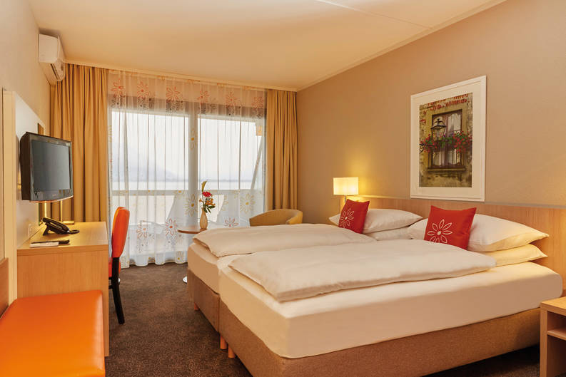 Chambre claire de l‘hôtel H4 Hotel Arcadia Locarno - site internet officiel