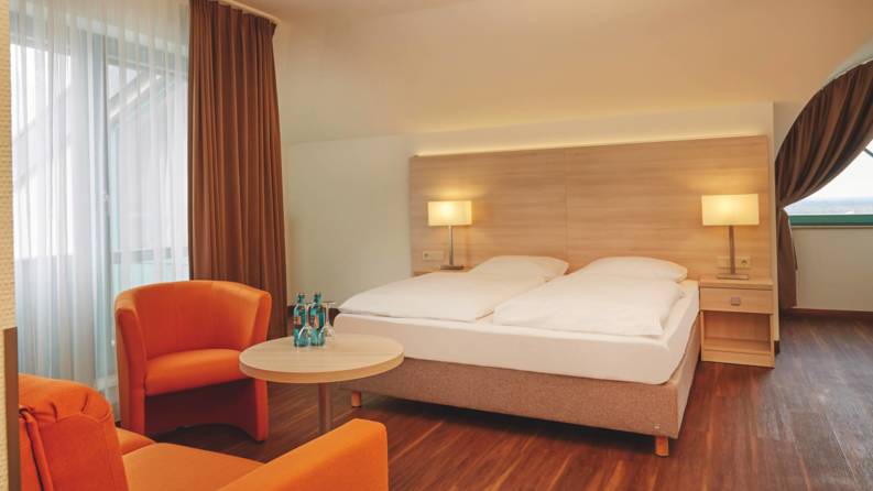 A modern hotel room at the H+ Hotel Limes Thermen Aalen - Official website