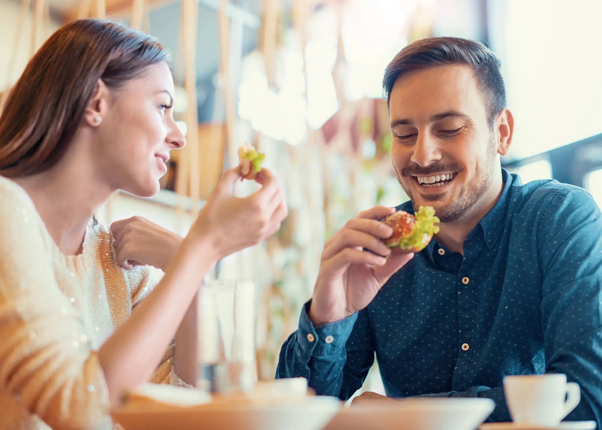 A couple are sitting at the table having breakfast.