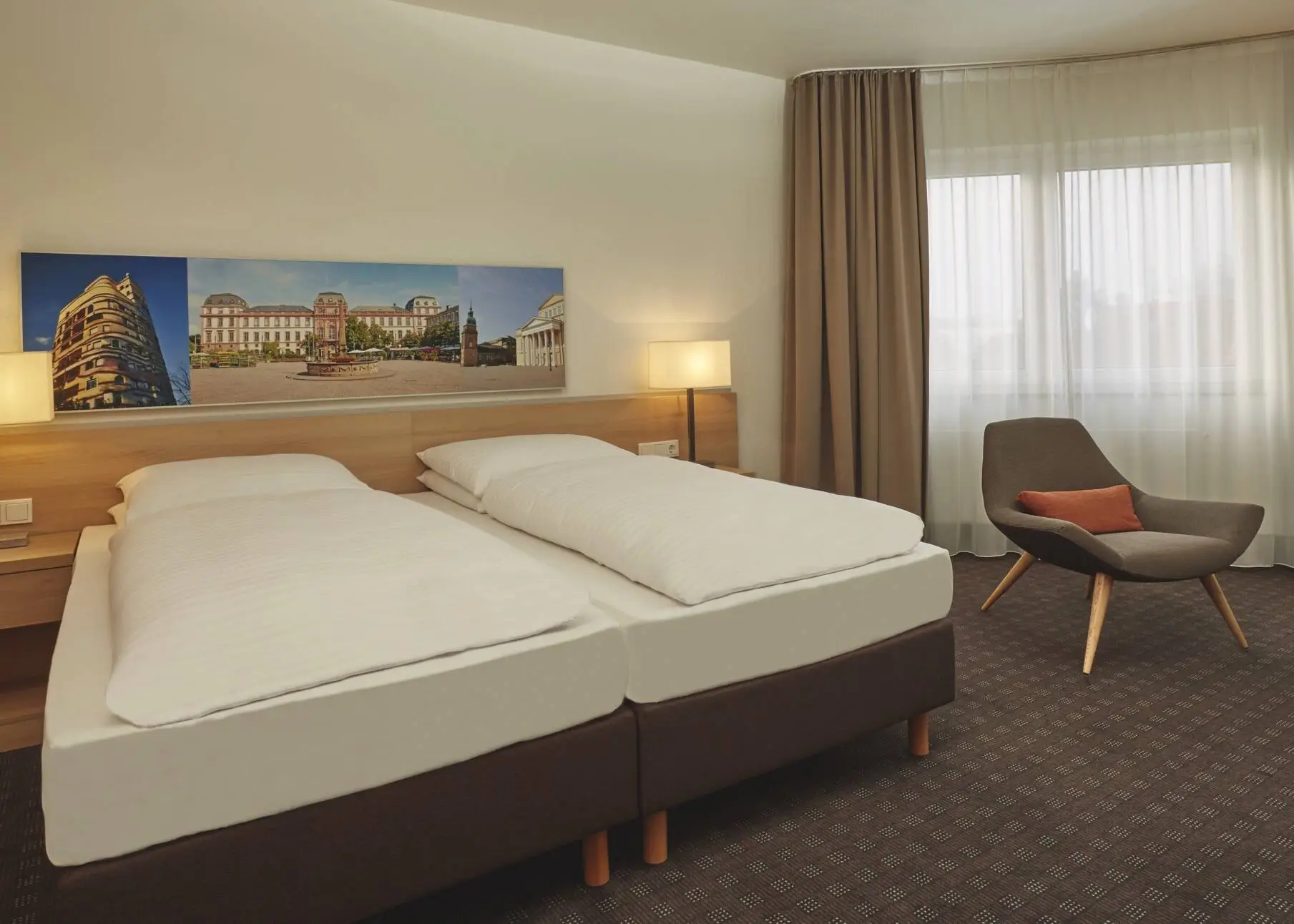Large hotel room with a double bed and a chair.