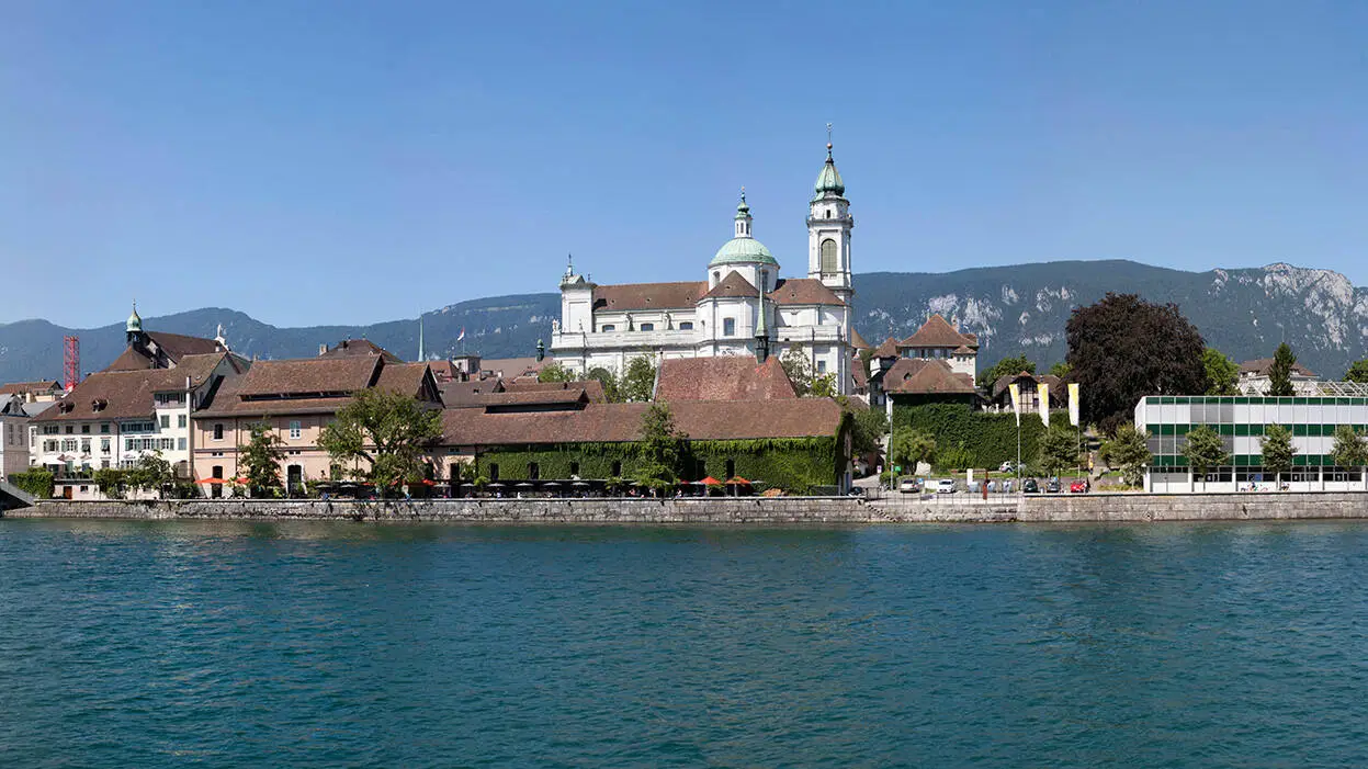 Blick auf die Skyline von Solothurn mit Bergen im Hintergrund.