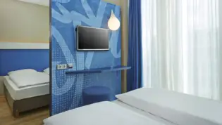 A comfortable hotel room at the H2 Hotel München Messe - Official website