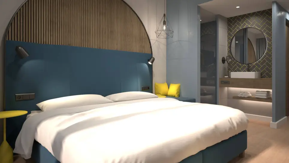 Habitación de hotel con cama doble y cuarto de baño semiabierto. 
