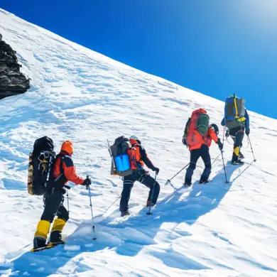 Four snowshoe hikers hike up a mountain