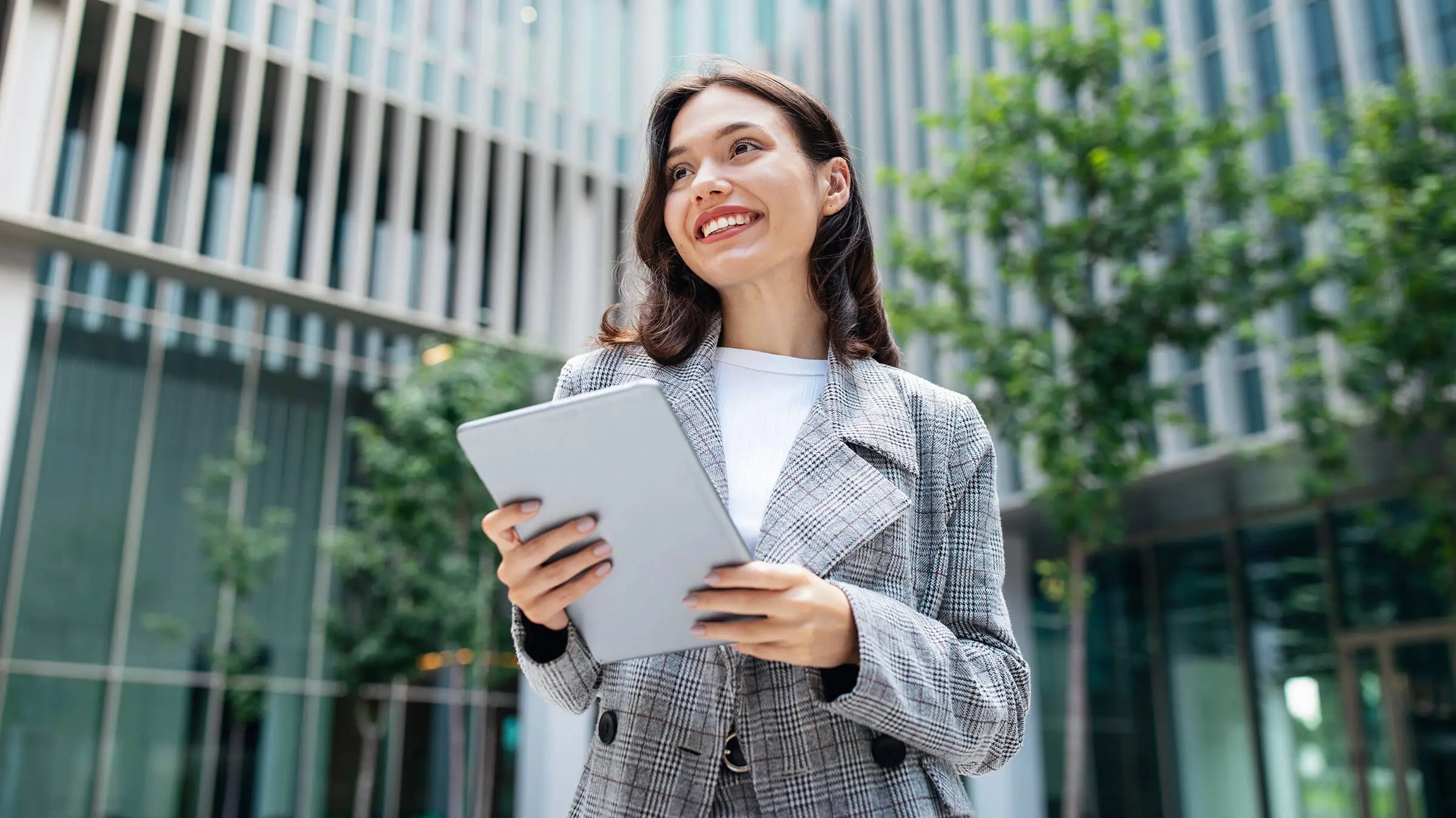 Man with a grey suit holding a tablet Man with a grey suit holding a tablet
