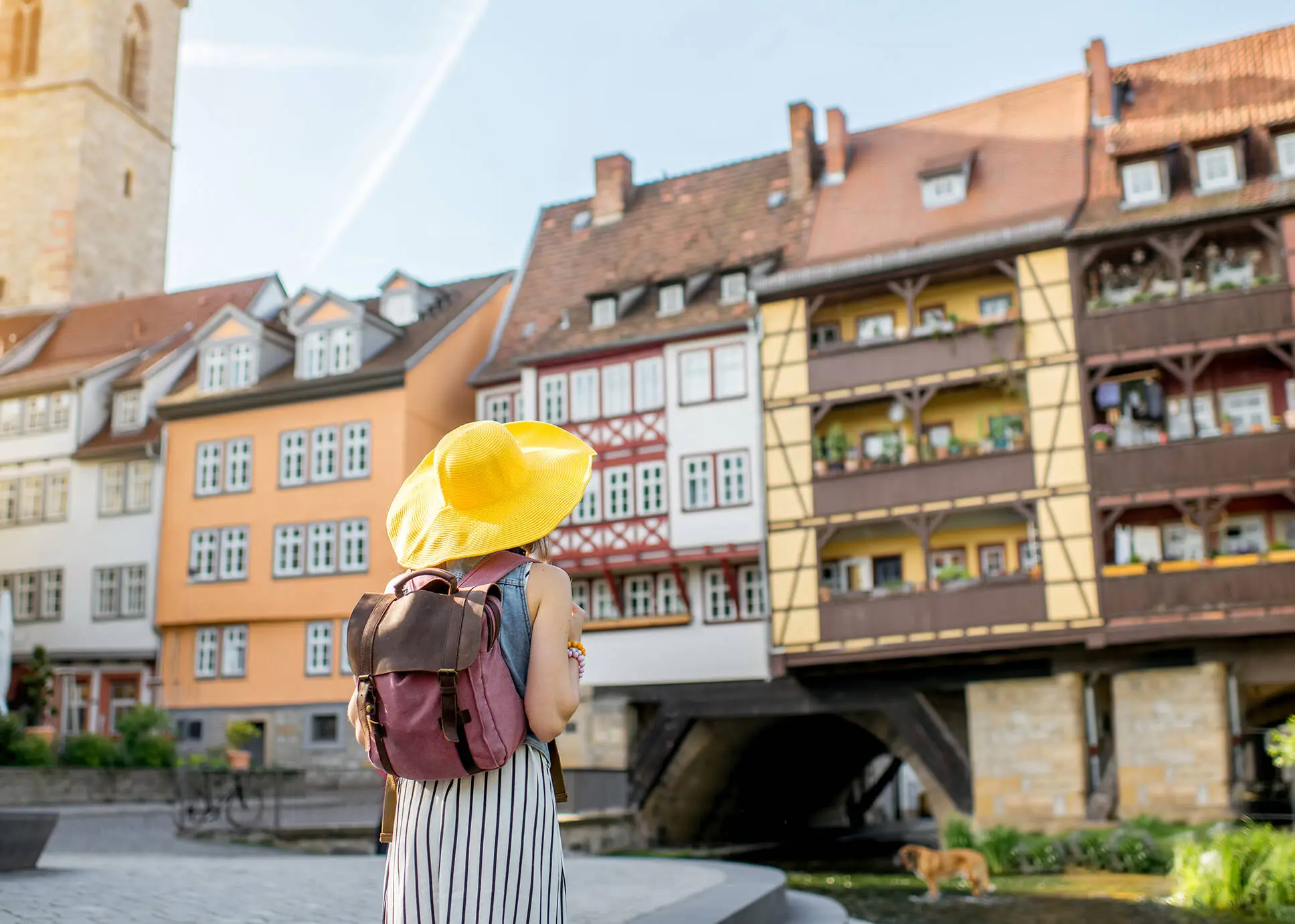 Frau mit gelben Sonnenhut schaut auf die Krämerbrücke.