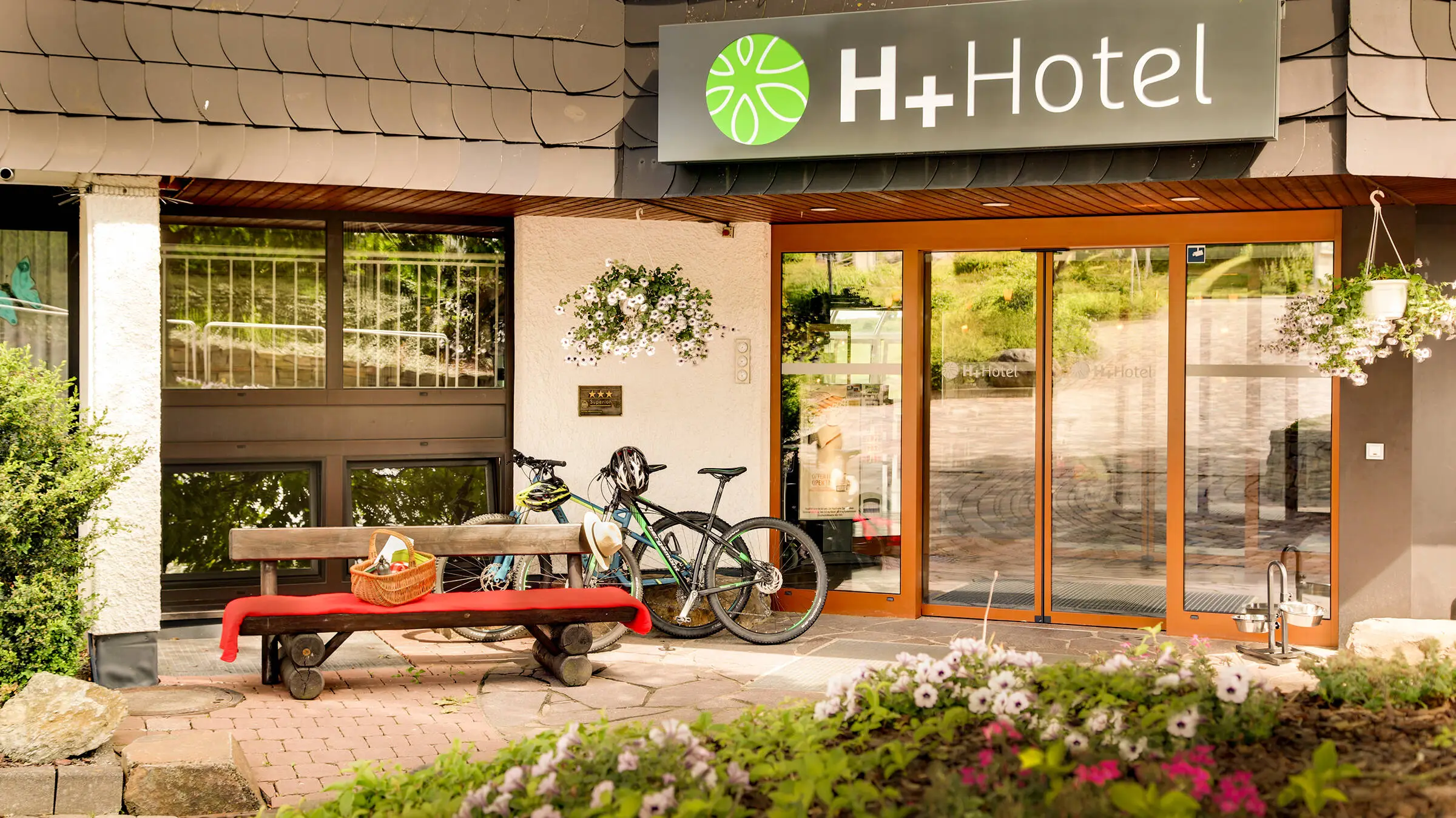 Hotel entrance of the H+ Hotel Willingen with bicycles.