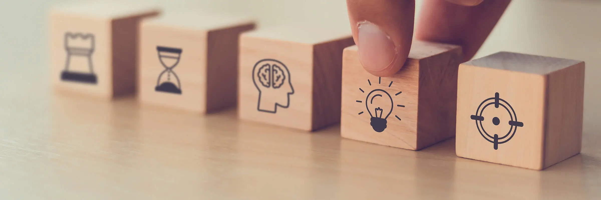 Three small wooden cubes with different pictograms.