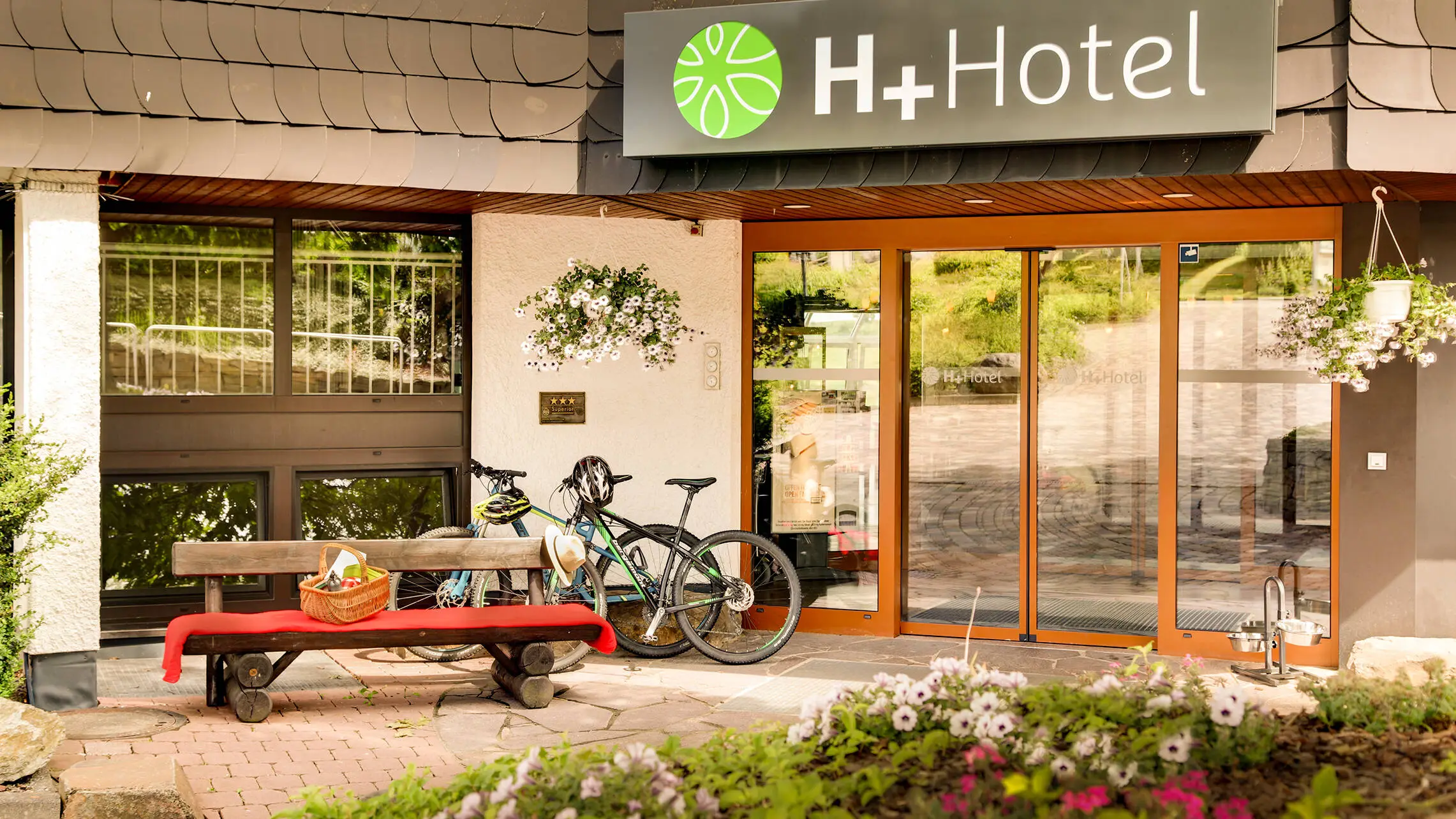 Hotel entrance of the H+ Hotel Willingen with bicycles.