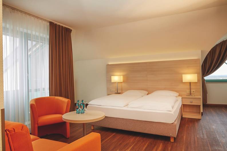 A modern hotel room at the H+ Hotel Limes Thermen Aalen - Official website