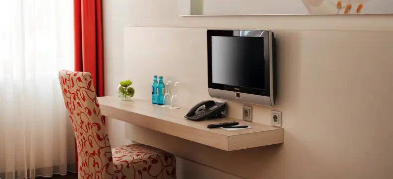 Nahaufnahme vom Schreibtisch mit einem Fernseher und einem Stuhl.