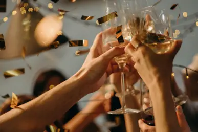 Champagne glasses are clinked together