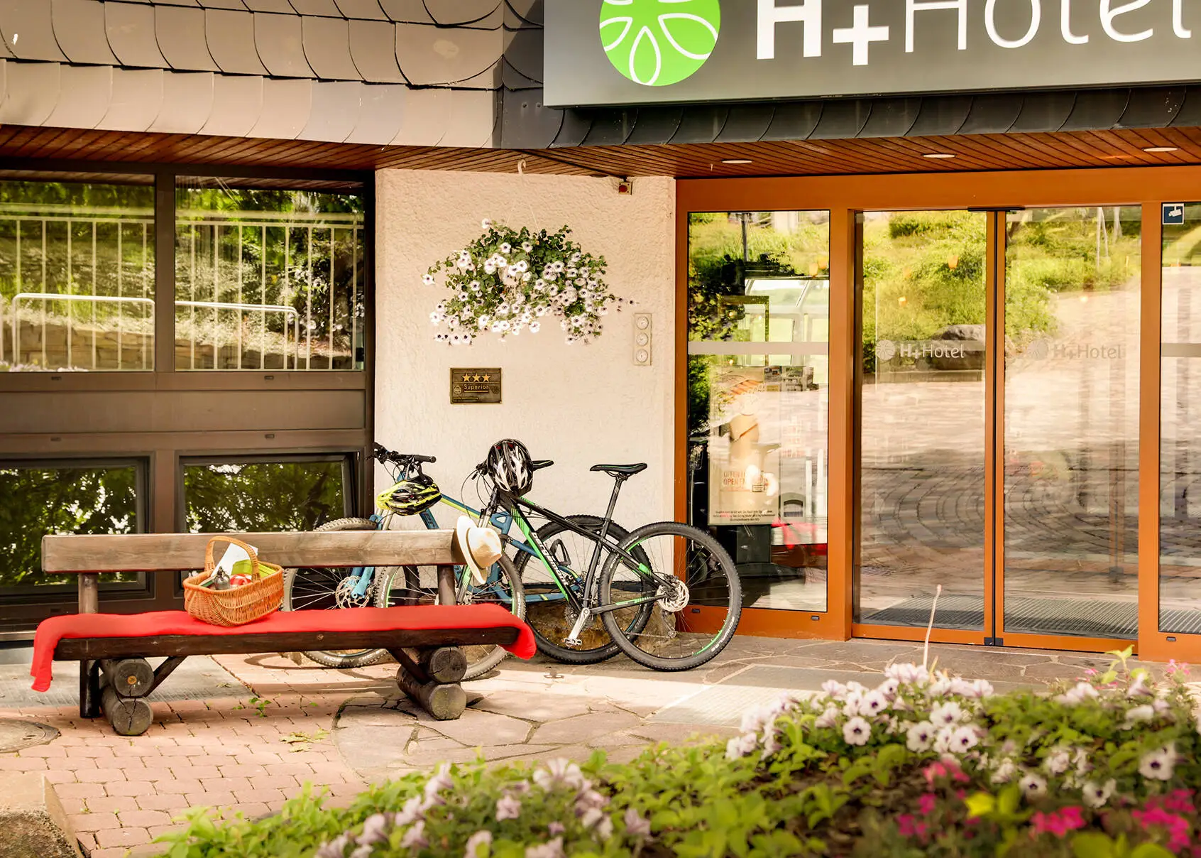 Hotel entrance of the H+ Hotel Willingen with bicycles.