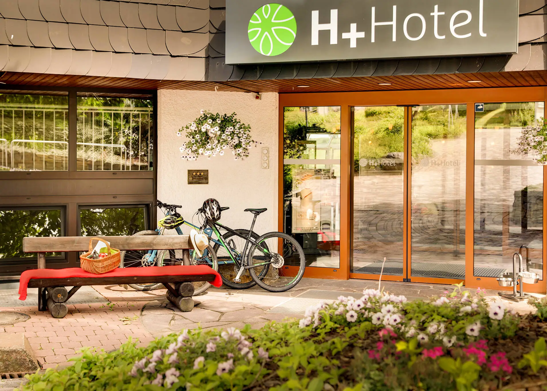 Hotel entrance of the H+ Hotel Willingen with bicycles.